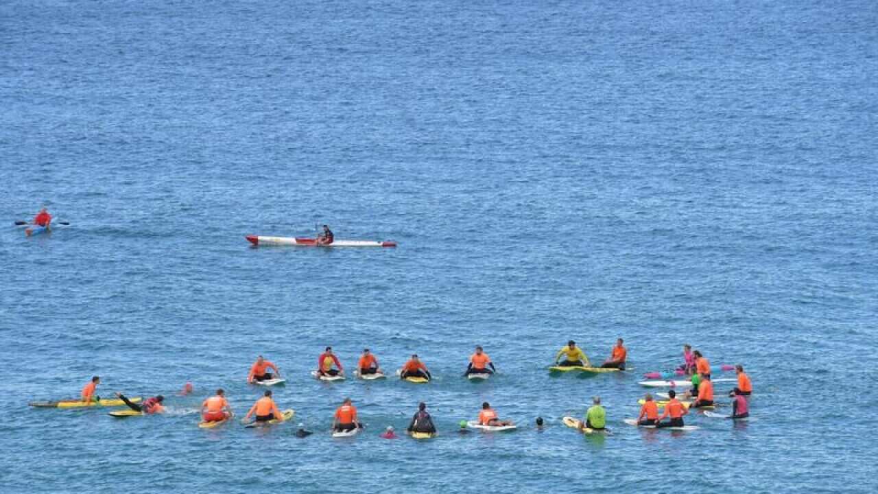 Surf lifesavers during a memorial for SA nurse Kirsty Boden