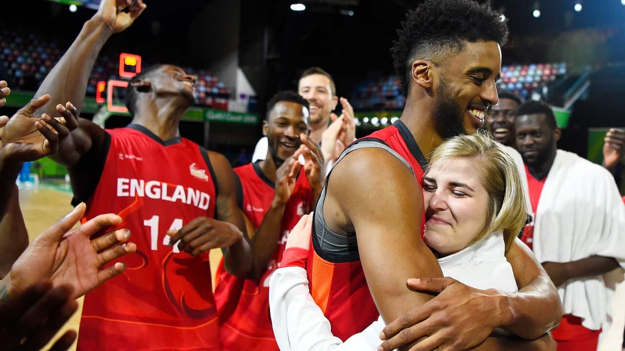 England Basketball players Jamell Anderson and Georgia Jones embrace after she agreed to marry him following England’s men’s team win over Cameroon in Townsville