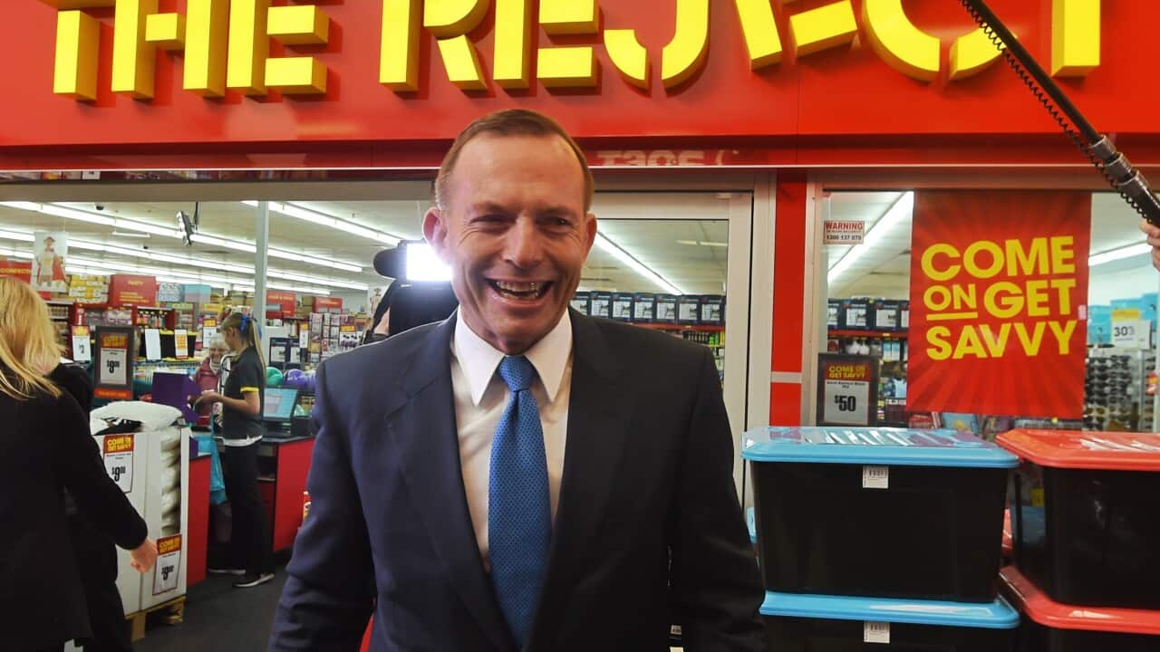 Prime Minister Tony Abbott on his way to visit a small business butchers shop at Kippax Fair in Canberra, Thursday, June 4, 2015. (AAP Image/Mick Tsikas)
