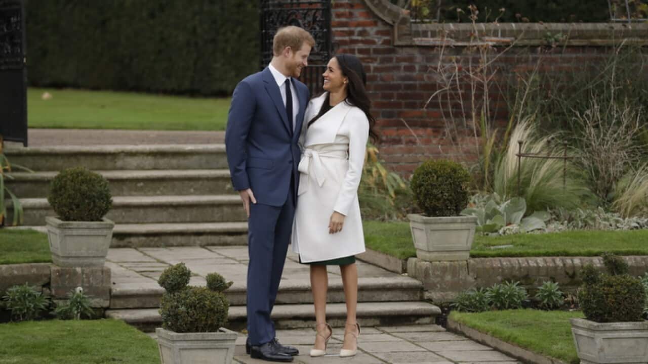 Britain's Prince Harry and his fiancee Meghan Markle pose for photographers during a photocall in the grounds of Kensington Palace in London.