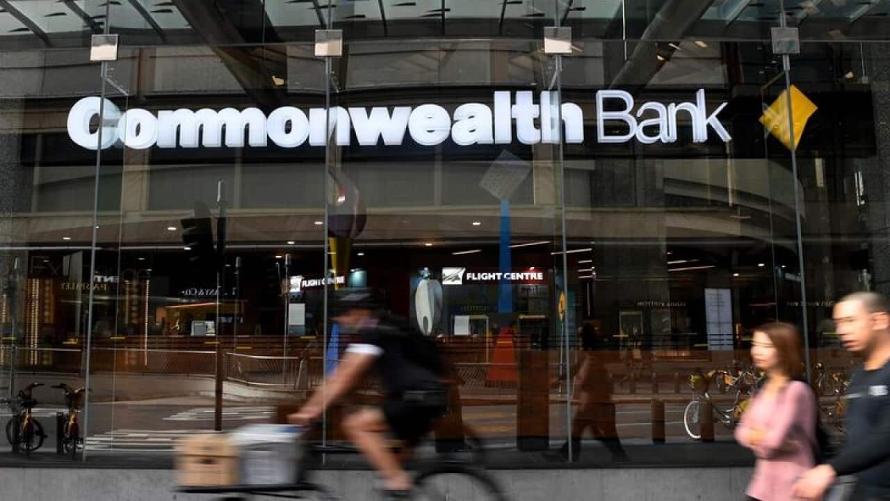 People walk by a Commonwealth Bank
