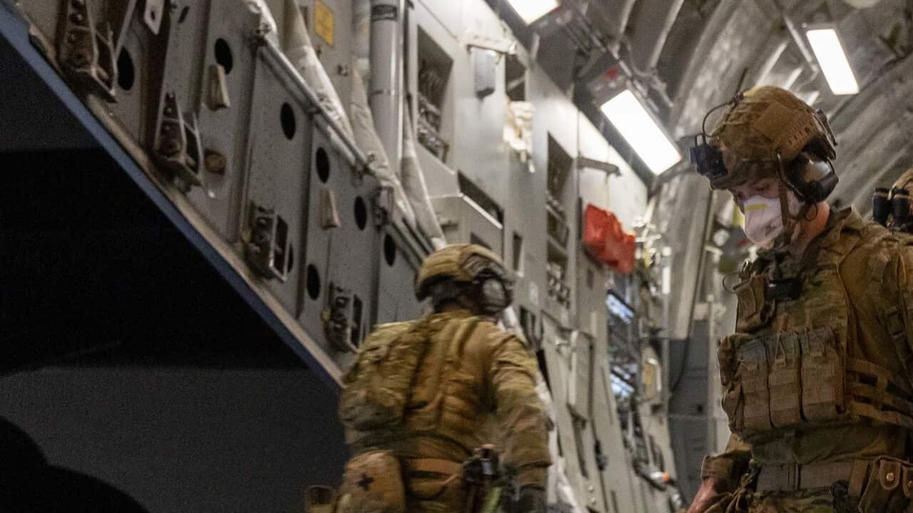 Australian Defence Force personnel unloading luggage from a Royal Australian Air Force C-17A Globemaster in the Middle East.