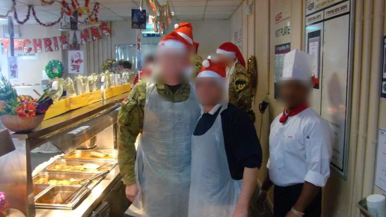 An Afghan man celebrates Christmas with an Australian solider at the Camp Qargha military base in Kabul, Afghanistan. (Supplied).png