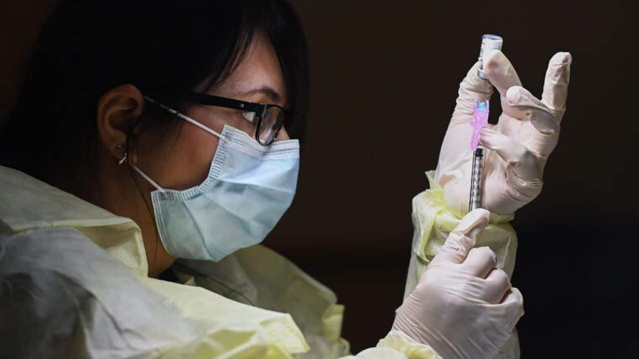 Francesca Paceri, a registered pharmacist technician, carefully fills the Pfizer-BioNTech COVID-19 mRNA vaccine at a clinic in Toronto, Tuesday, Dec. 15, 2020.