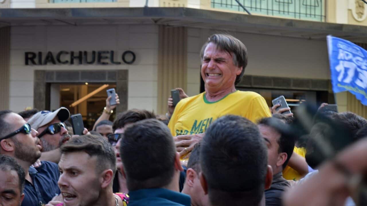 Brazilian right-wing presidential candidate Jair Bolsonaro winces in pain after being stabbed at a campaign rally.