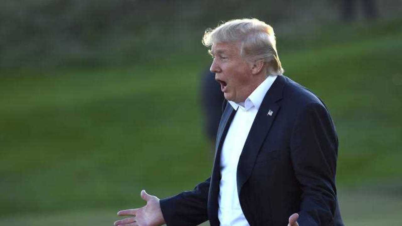 President Donald Trump reacts as he walks over to participate in presenting the Presidents Cup to the United States team at the Jersey City Golf Club in Jersey City, N.J., Sunday, Oct. 1, 2017.