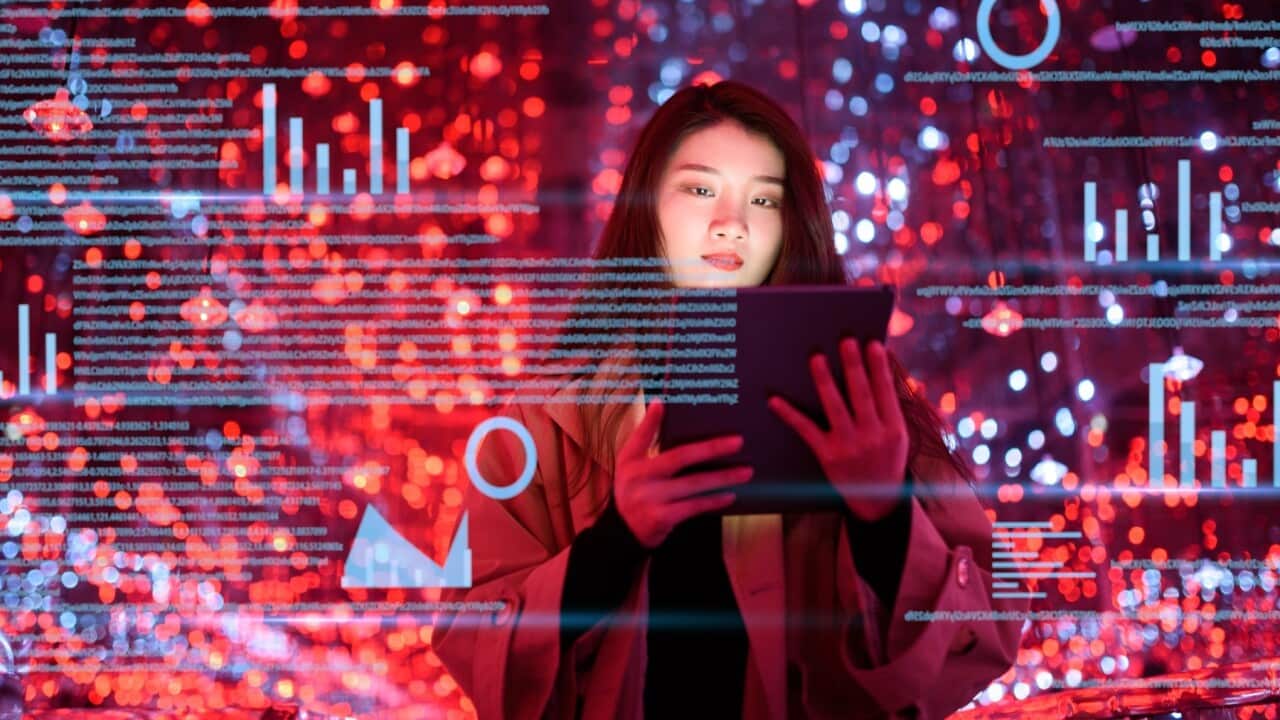 Young woman uses visual tablet at night - Dowell - Getty Images