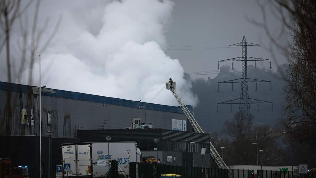 Firefighters spray water after lithium batteries caught fire at a French factory