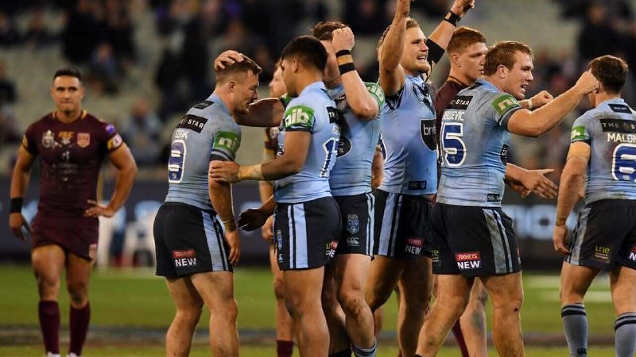 Blues players celebrate after winning Game 1.