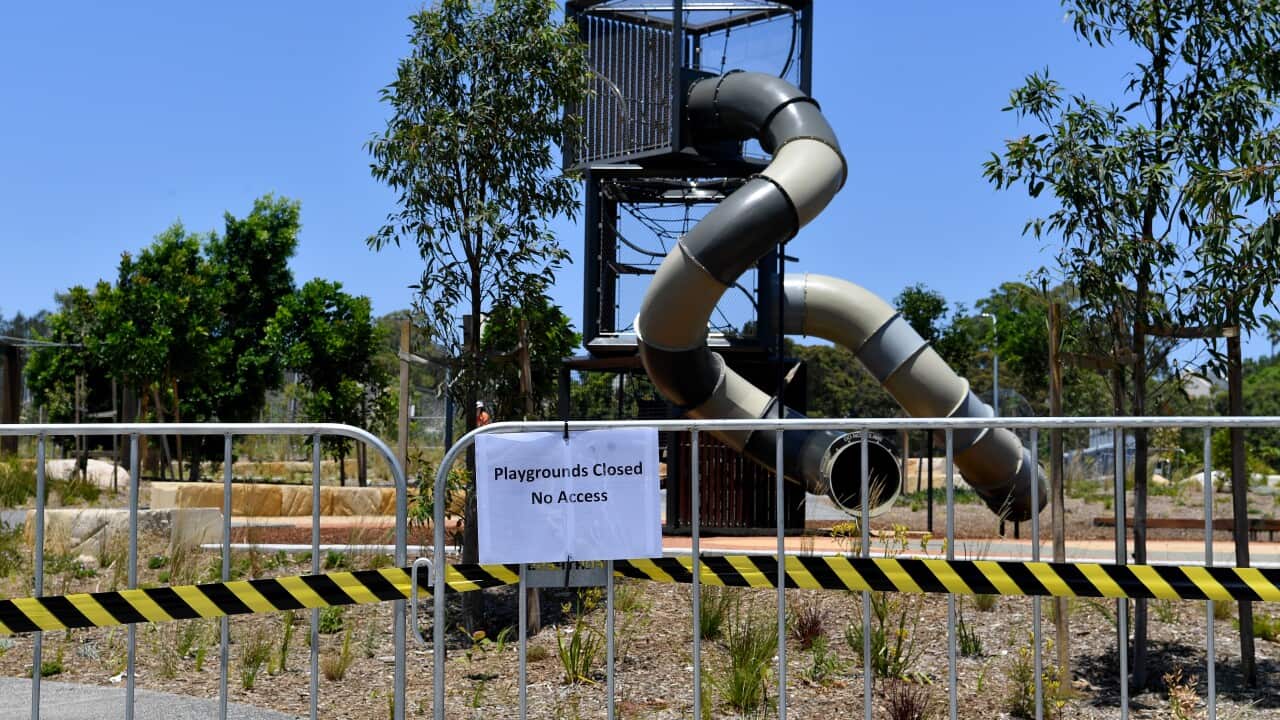 A playground with a barrier in front of it and a sign that reads 'Playgrounds Closed No Access'.