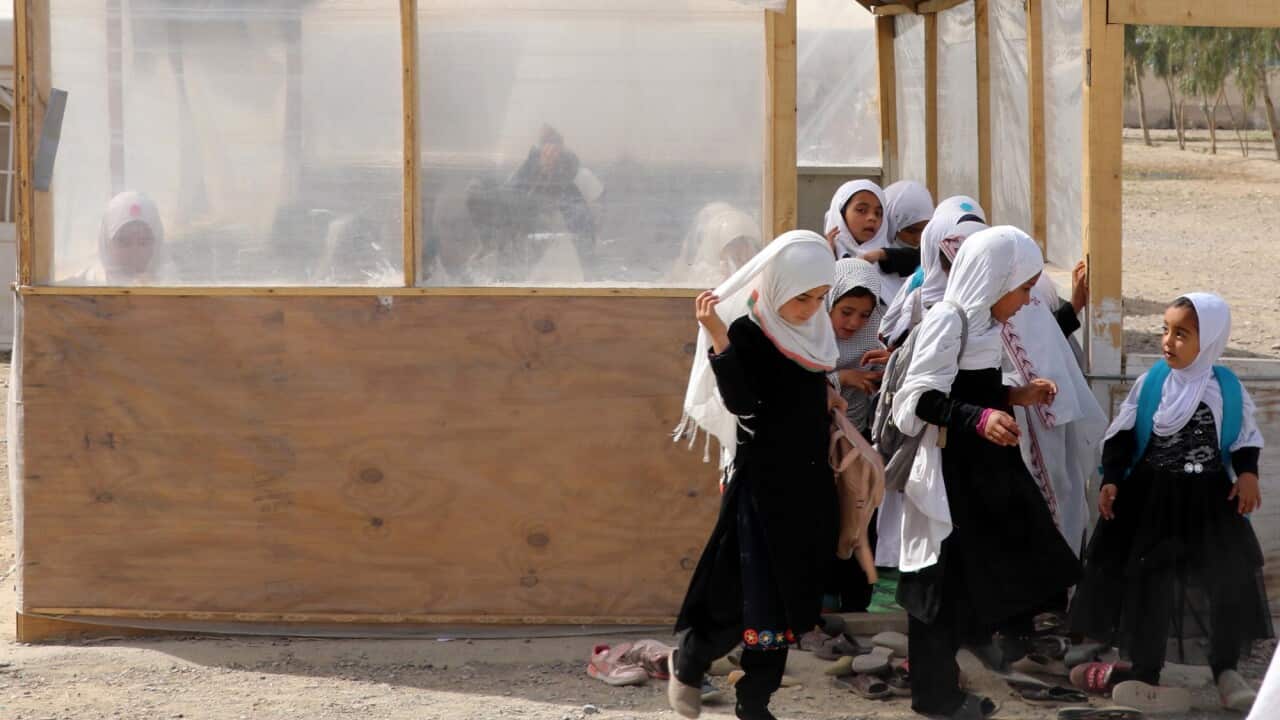 Afghan girls of up to primary grades leave a class at their school in Kandahar, Afghanistan, 23 March 2022.