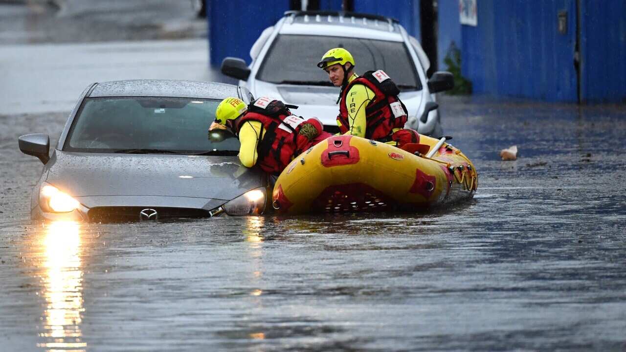 A team from Queensland Fire and Emergency Services searching flooded cars in Brisbane on October 27, 2020