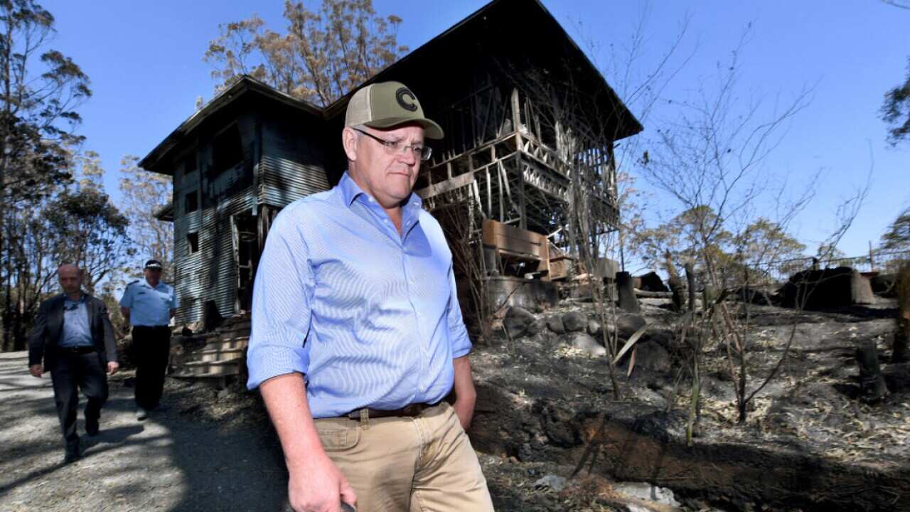 Australian Prime Minister Scott Morrison is seen inspecting burnt out property during a visit to the bushfire affected area of Binna Burra.