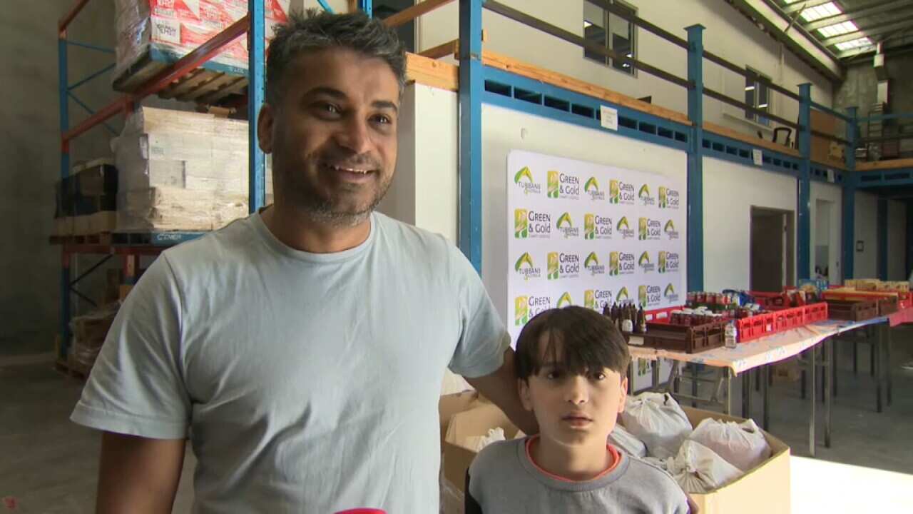 Divesh Sareen and his son volunteering for Turbans 4 Australia in Melbourne - SBS .jpg