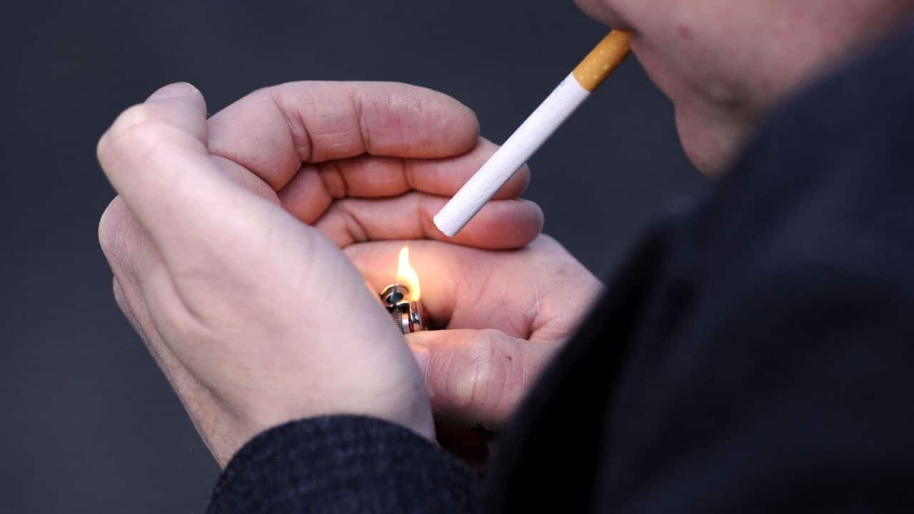 A man lighting a cigarette