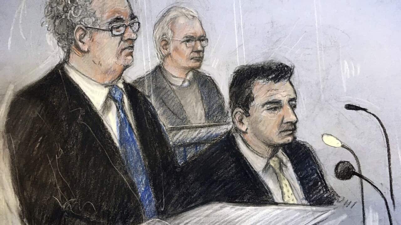 Court artist sketch by Elizabeth Cook of Julian Assange in the dock with his defence team, Edward Fitzgerald QC (left) and Mark Simmons QC.
