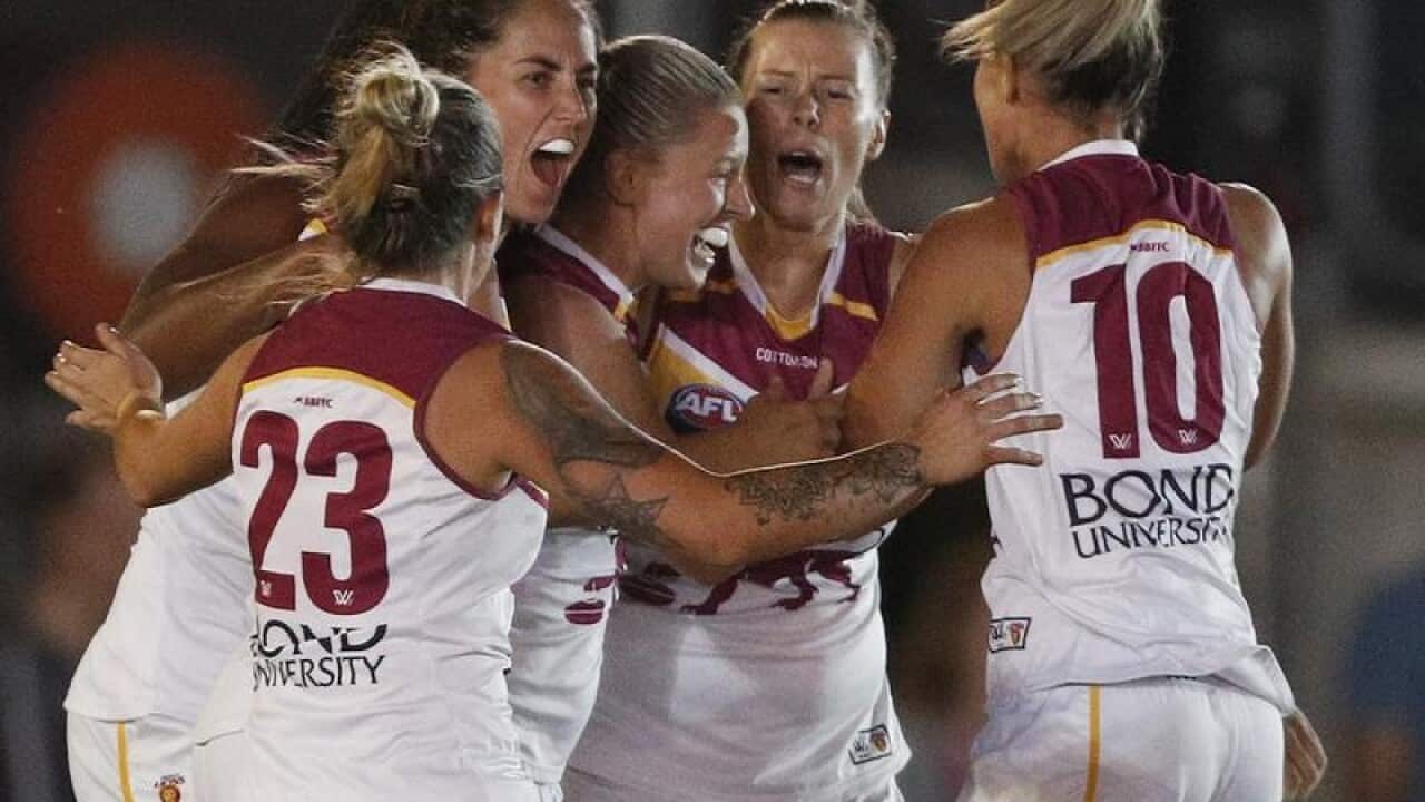 Brittany Gibson of the Lions celebrates a goal with her teammates.