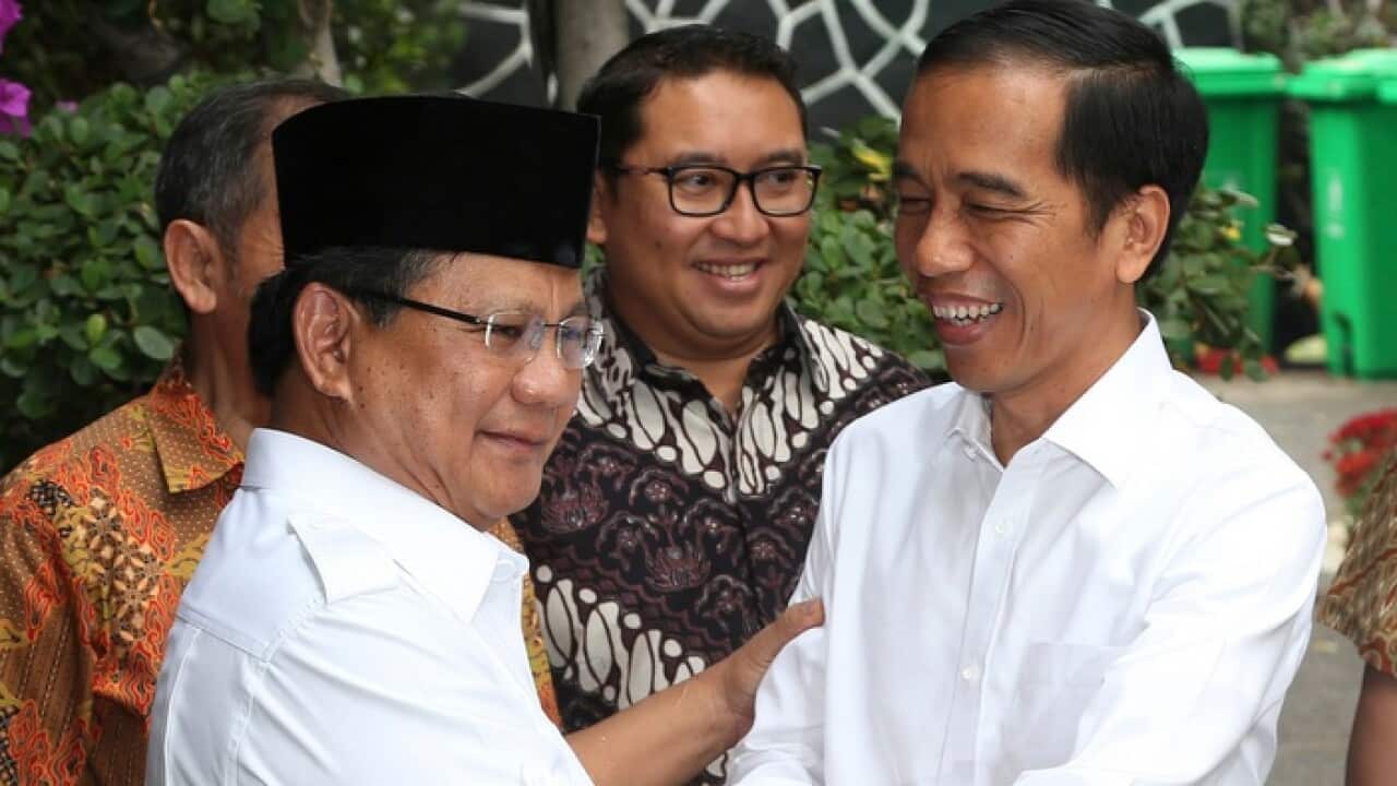 Indonesia's President-elect Joko Widodo, right, greets his political rival Prabowo Subianto during a meeting in Jakarta, Indonesia.