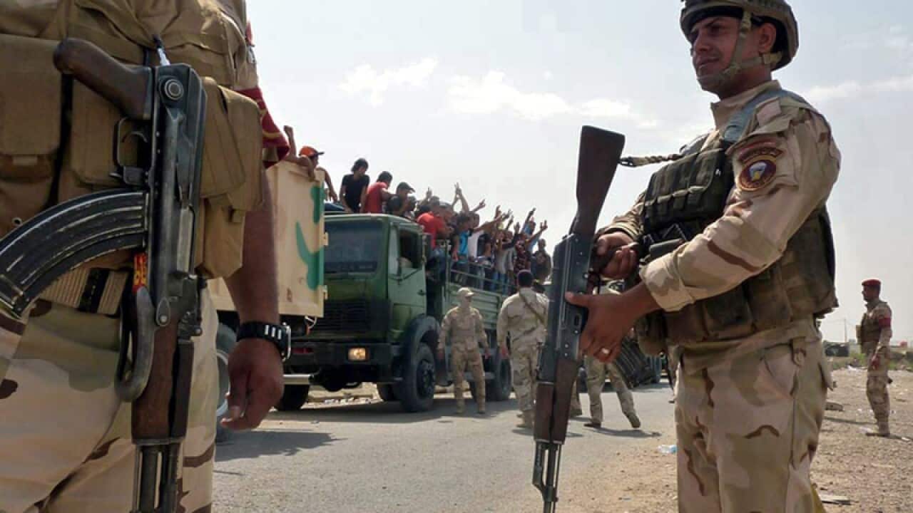 Iraqi military trucks transport volunteers to Muthanna base, Baghdad