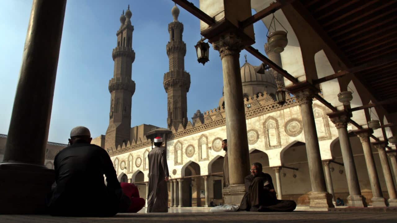 Muslims rest as they wait for the Friday noon prayer at Al-Azhar mosque in Cairo, Egypt. (AP Photo/Khalil Hamra, File)