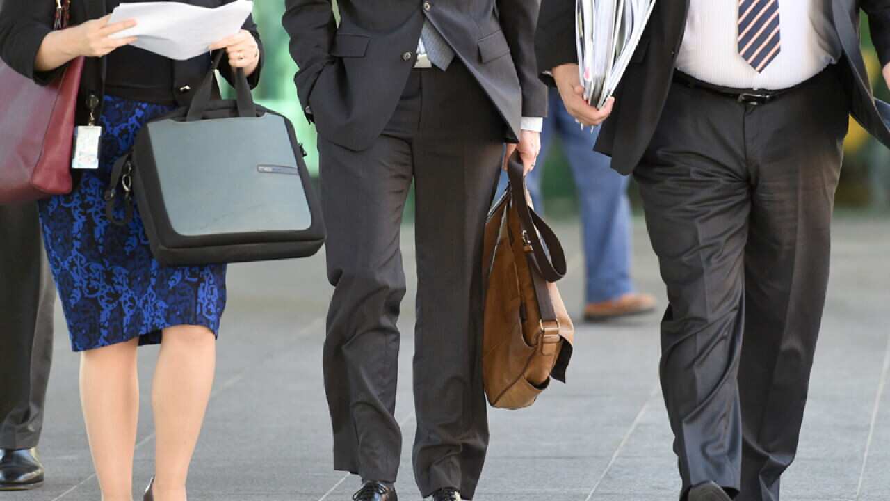 Office workers walk through Brisbane