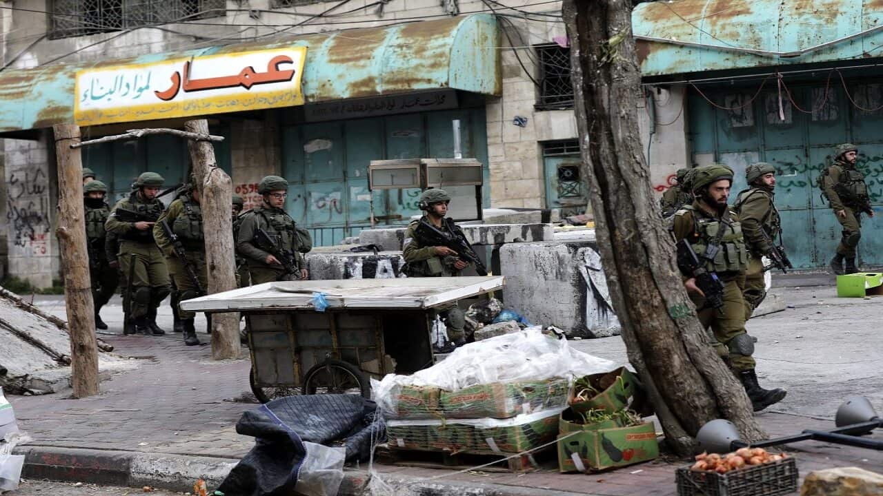 Israeli troops patrol during clashes in Hebron, West Bank.