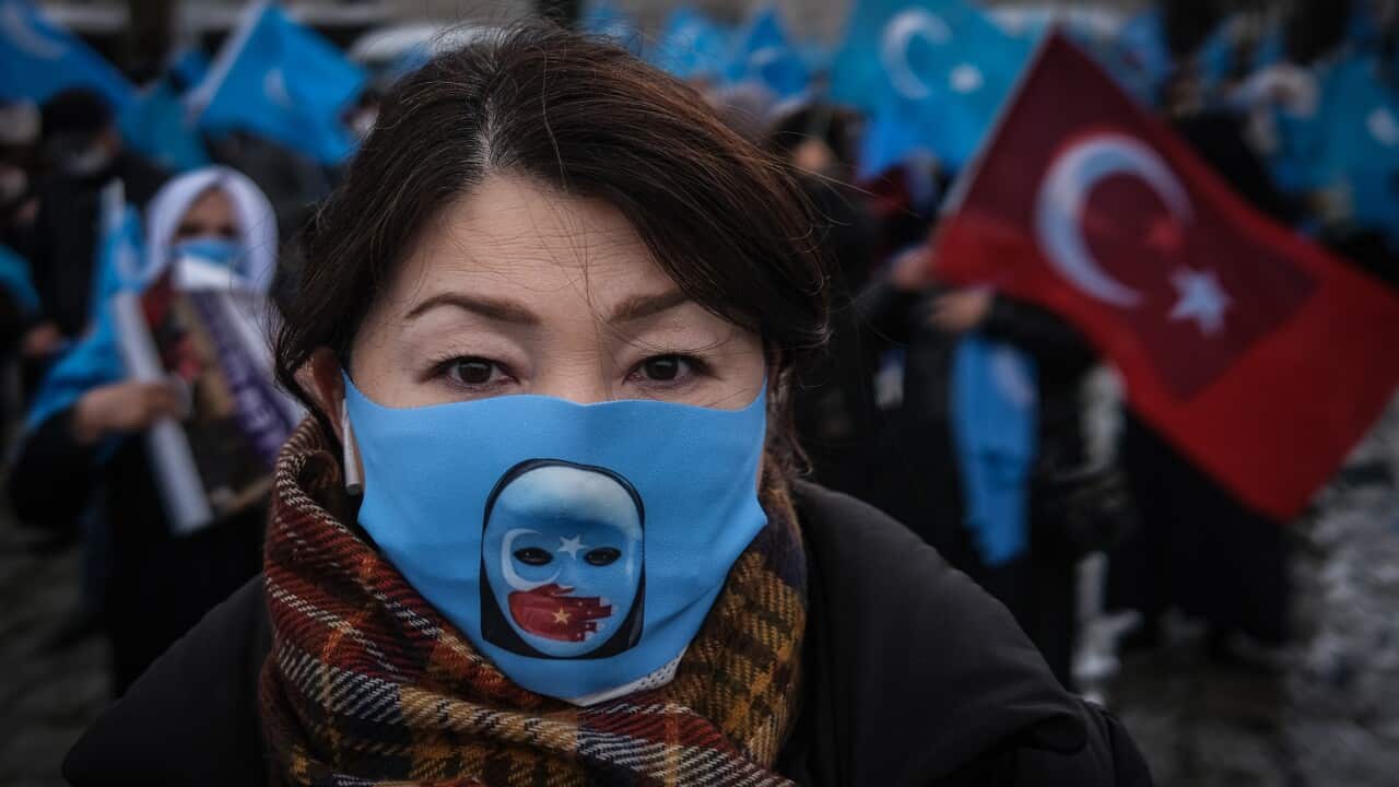 Uighur protesters who have not heard from their families living in East Turkestan hold flags during a protest against China, in Istanbul, 25 March 2021.