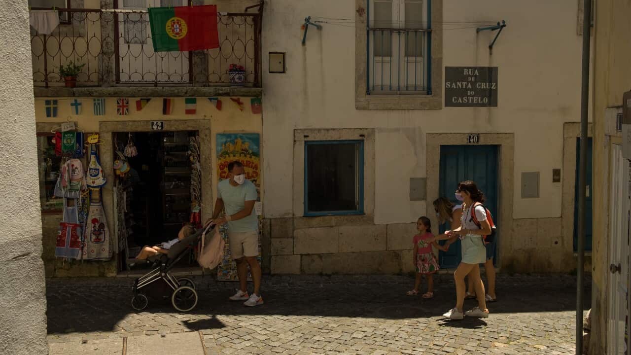 Visitors and tourists are seen walking in the city downtown wearing face masks in Lisbon, Portugal.