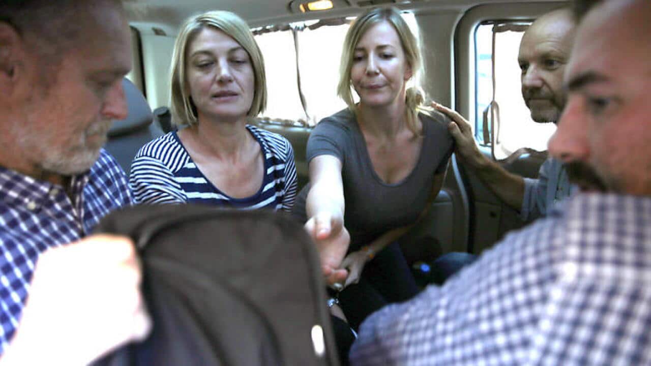 Members of Australian '60 Minutes' television crew greet Australian Sally Faulkner (C) and Australian reporter Tara Brown (2-L) after they left Baabda Prison (AAP)
