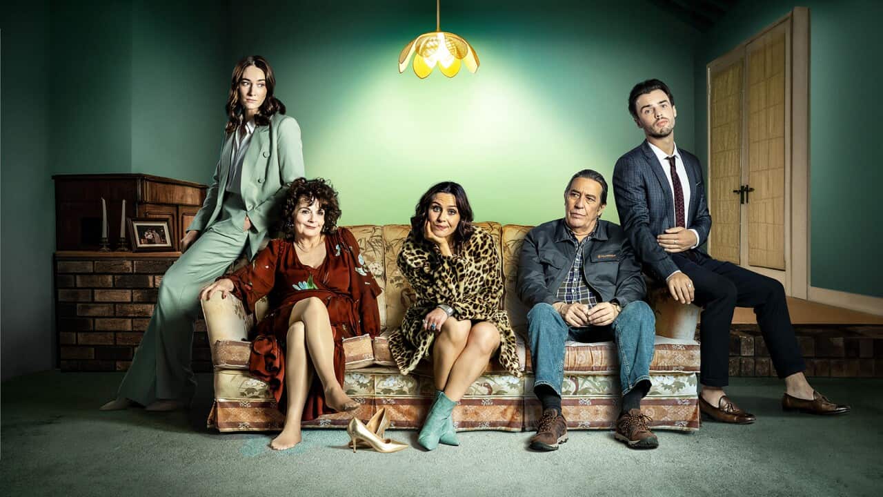 Five sit or lean on a couch.