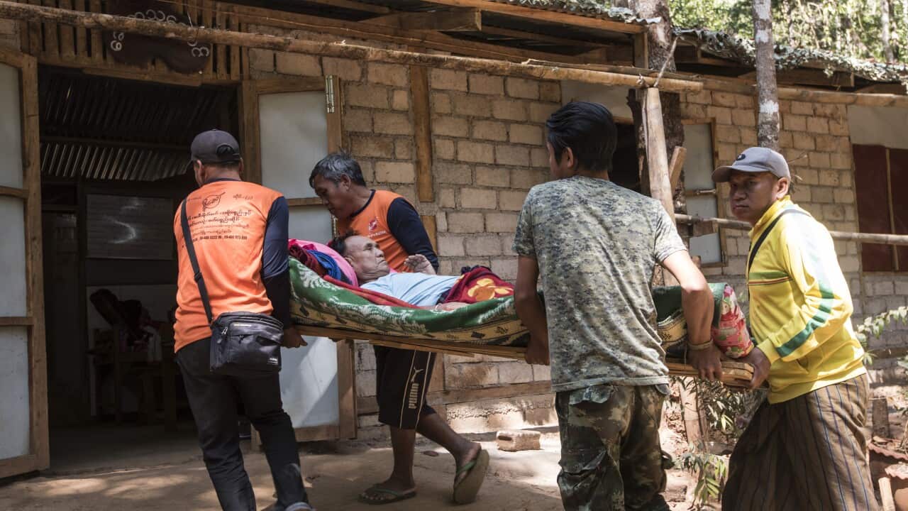 A civilian injured by a Burmese army airstrike is carried