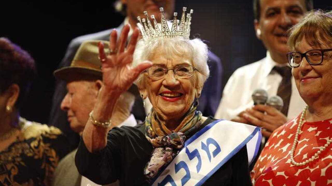 93-year-old holocaust survivor Tova Ringer (C) reacts after winning the 2018 beauty queen contest during the Holocaust Survivor beauty pageant in Haifa, Israel, 14 October 2018.