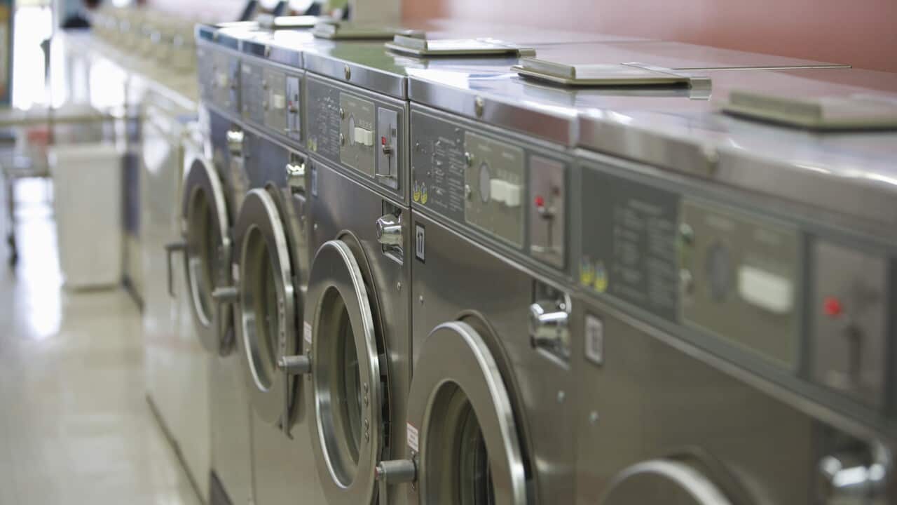 Row of washing machines in launderette