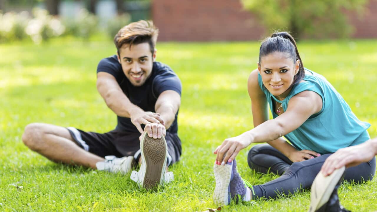 Friends exercising in park