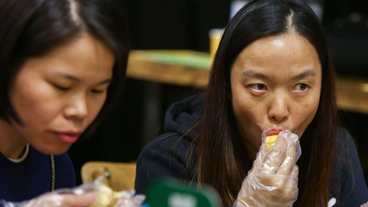 Wendy Deng Wenbo (left) and Cindy Wang Xianya (right), customers from Shenzhen eat durian at DurianBB at the King Win Factory Building in Kwun Tong. 25NOV17 SCMP / Xiaomei Chen