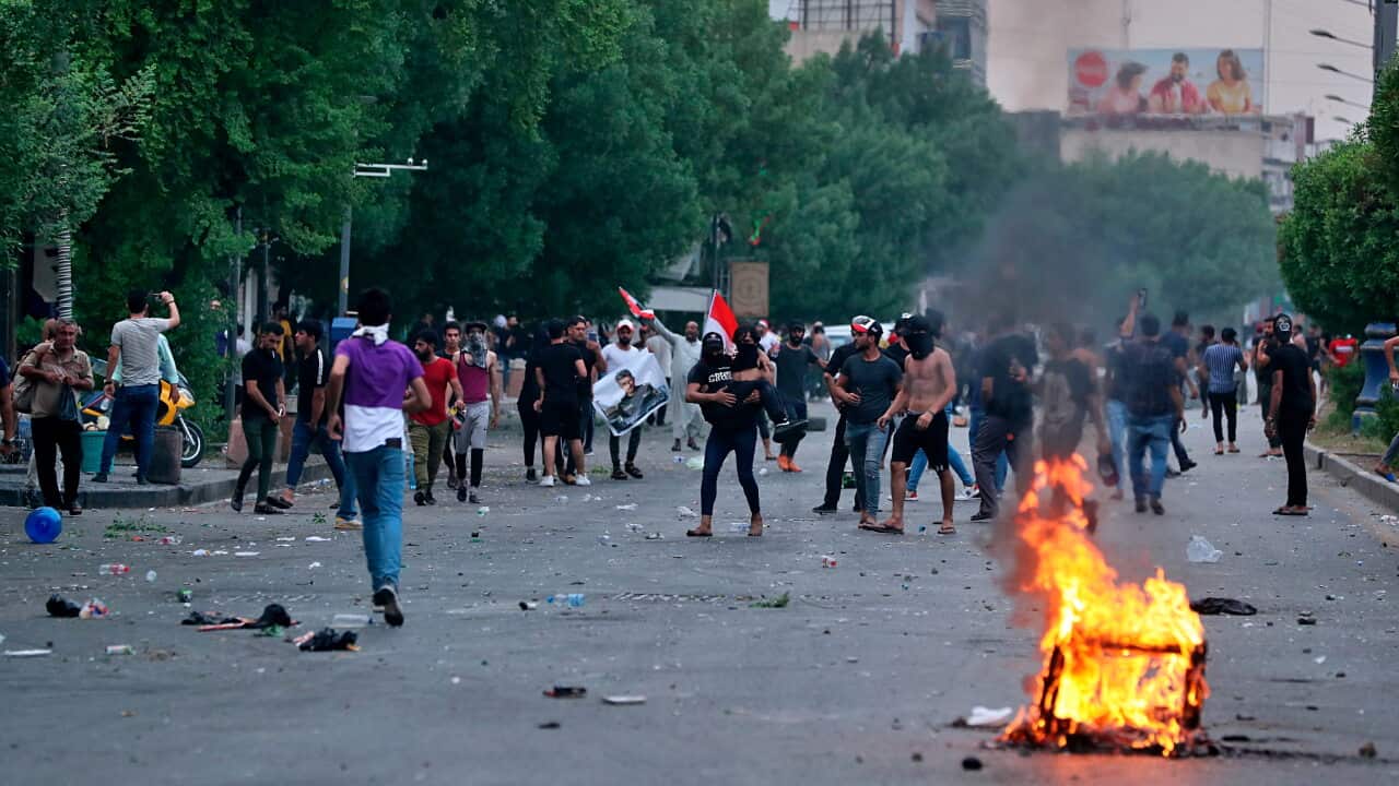 Protesters burn tires during a demonstration in Baghdad, Iraq, Tuesday, Oct. 1, 2019. Iraq officials say 1 person has been killed and 200 injured in confrontations between anti-government protesters and security forces in Baghdad. (AP Photo/Hadi Mizban)