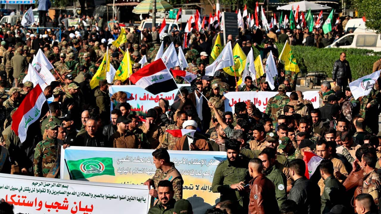 Iran-backed Popular Mobilization Forces gather outside the heavily fortified Green Zone, the seat of Iraq's government and the US embassy, in Baghdad, Iraq.