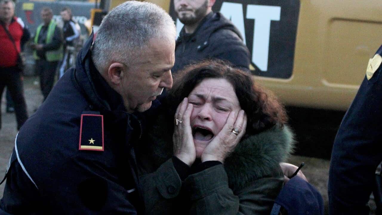 A woman cries as her relatives are trapped in a building after an earthquake hit Thumane, Albania.