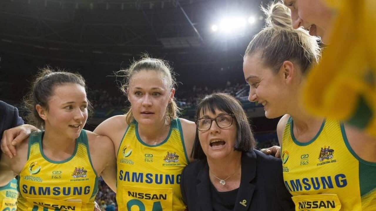Lisa Alexander, coach of the Diamonds in huddle with her team