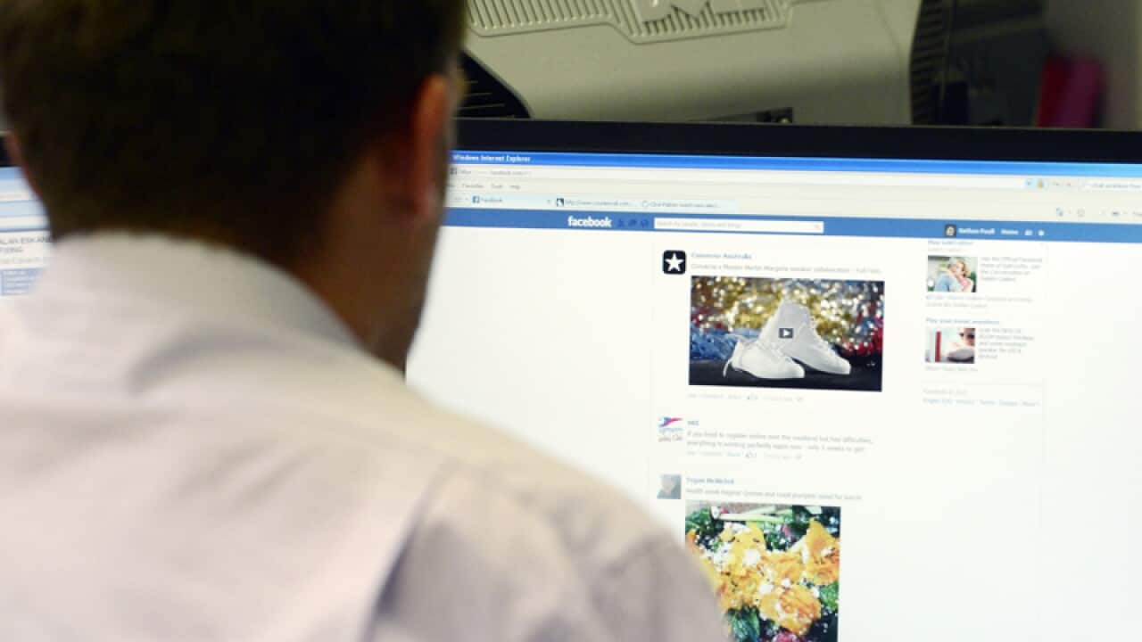 A man uses a desktop computer