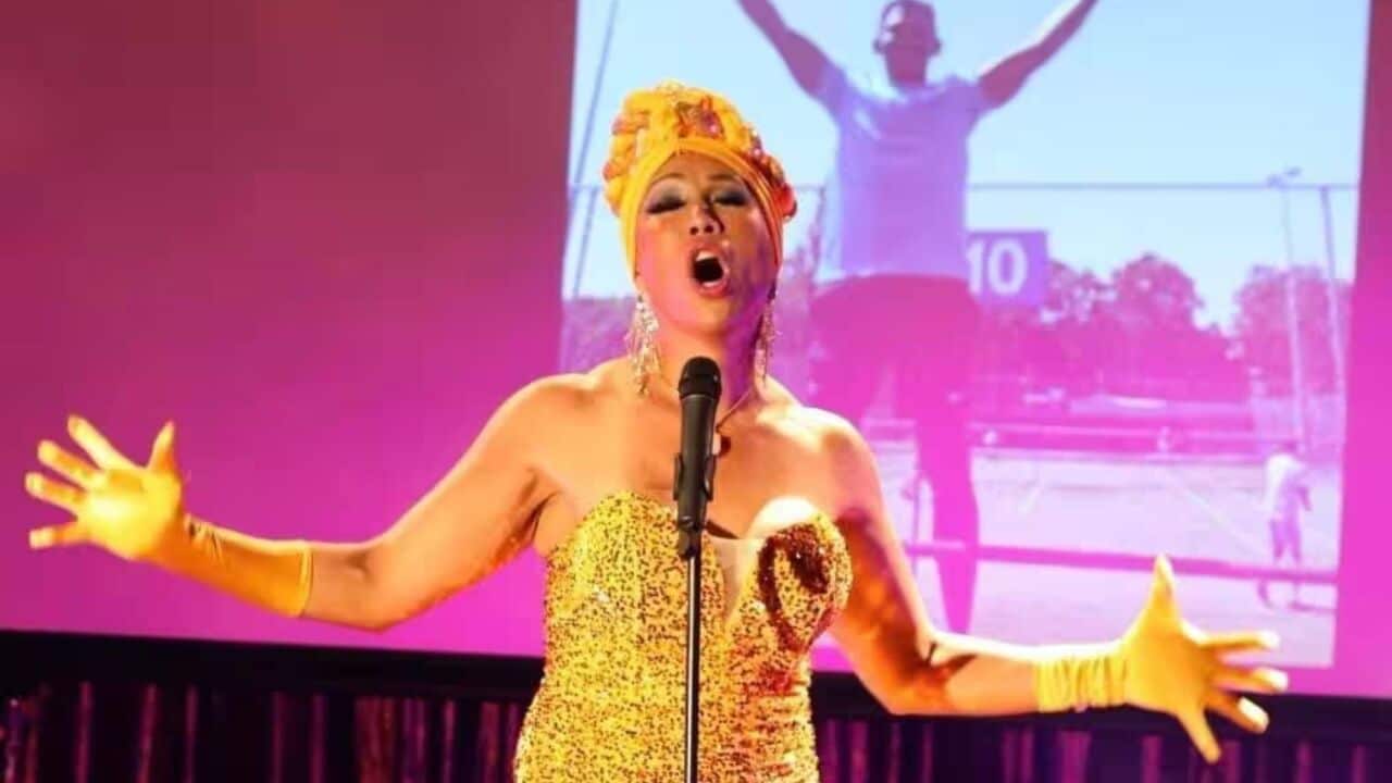 Linda Montana in a yellow costume on stage.