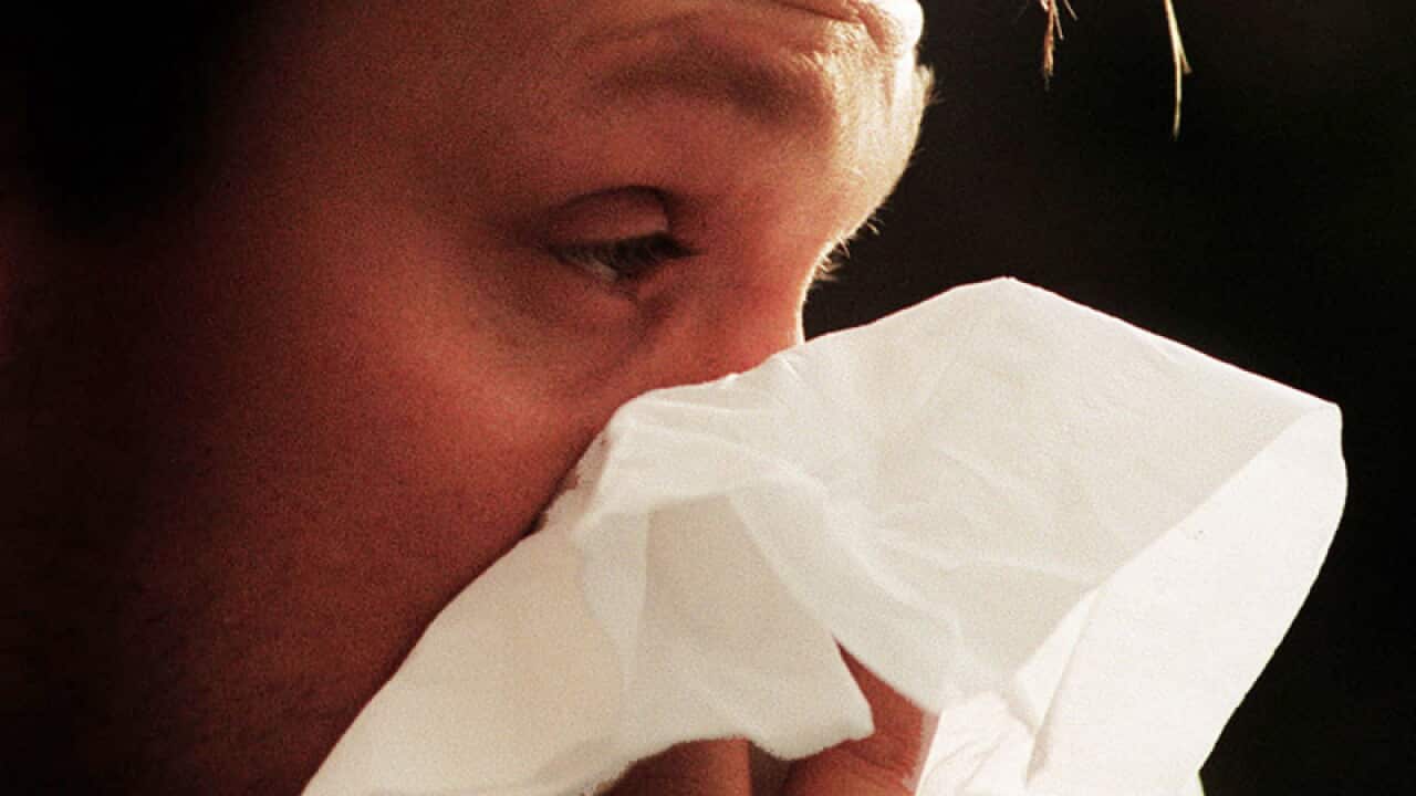 A man blows his nose