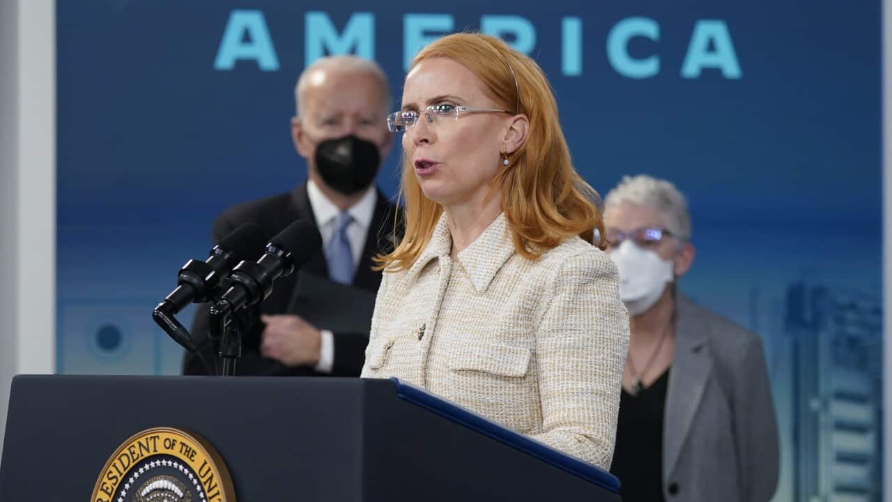 President Joe Biden listens as Jane Hunter, CEO of Tritium, speaks about electric vehicle chargers.