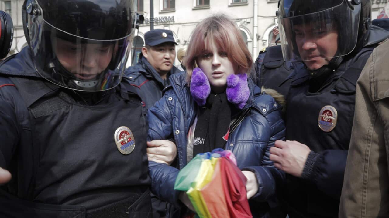 A gay rights activist is detained by police in St. Petersburg