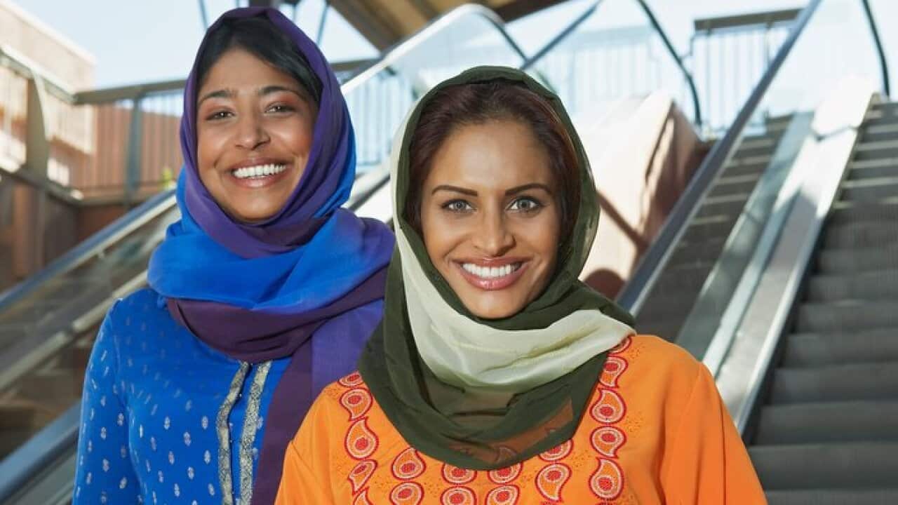 Portrait of two muslim women with shopping bags