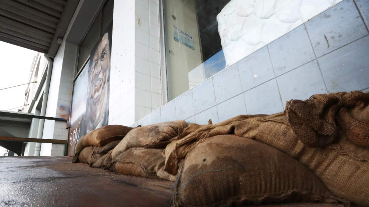 Sandbags against a store front.