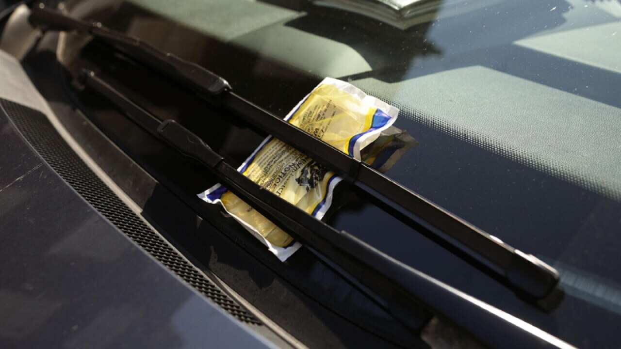 A parking ticket on a car windscreen