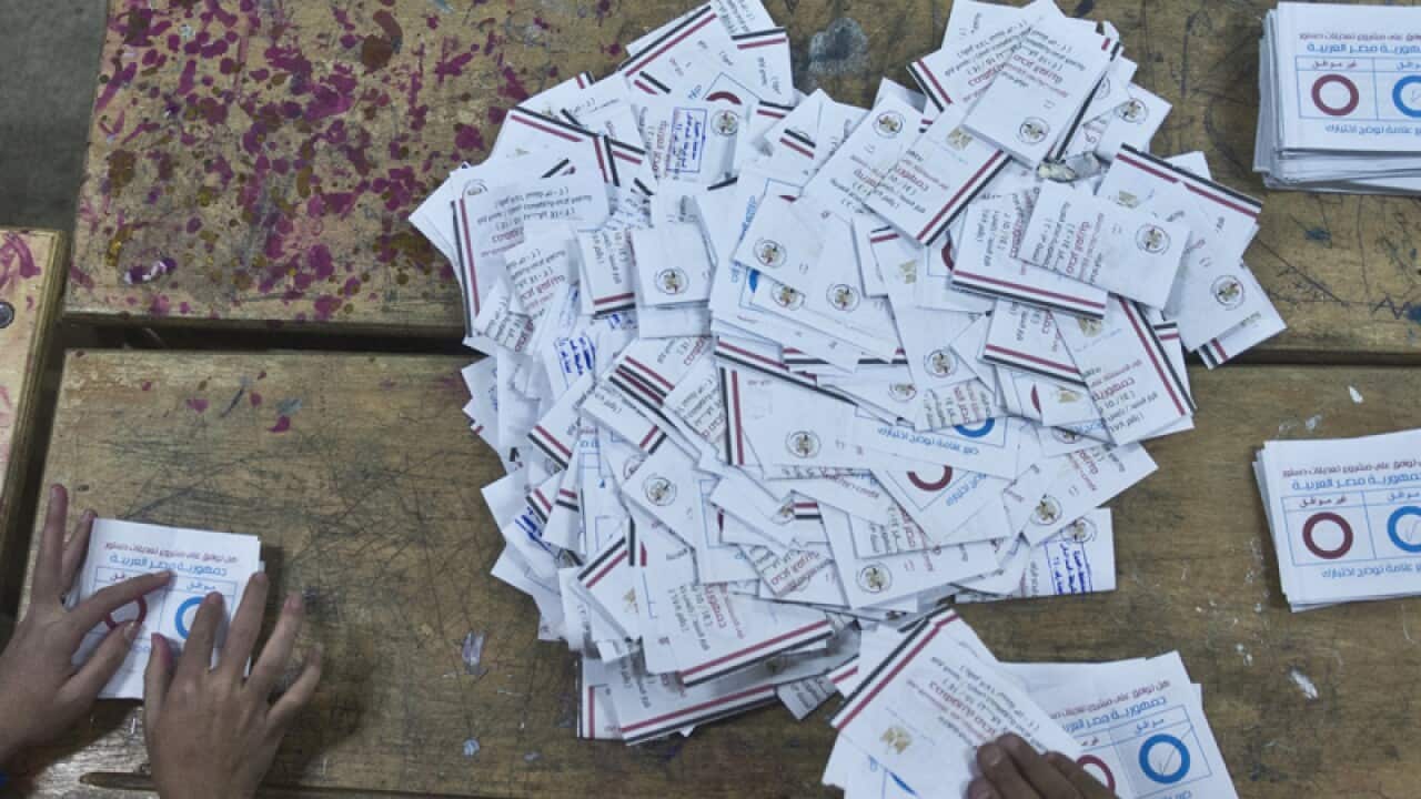 Polling station officials count ballots