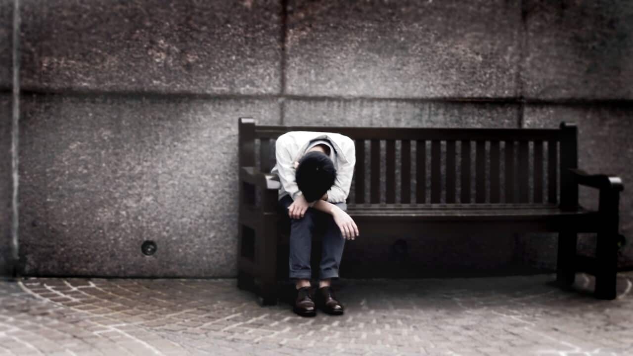 Depressed man sitting on bench