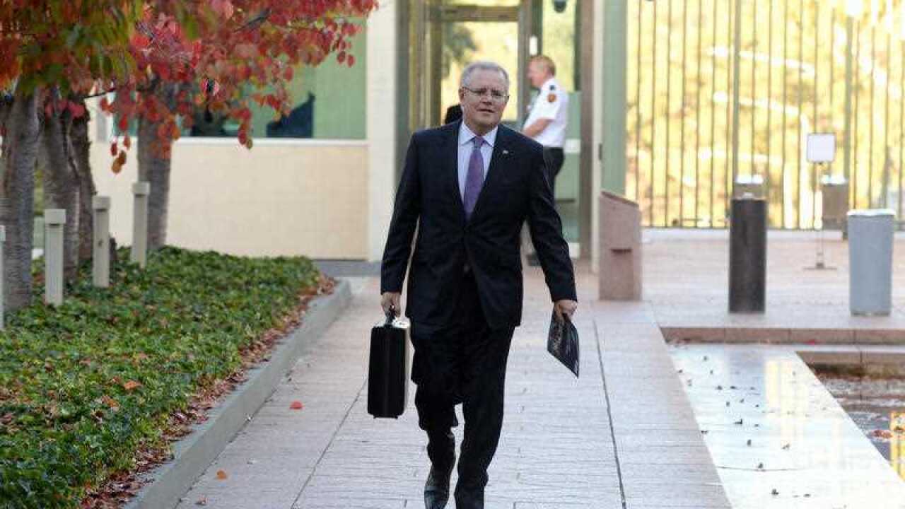 Australian Federal Treasurer Scott Morrison arrives for a photo opportunity before he delivers the Budget later today at Parliament House in Canberra, Tuesday,
